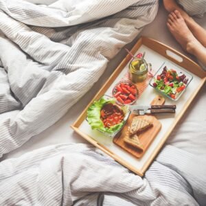 Enjoy a delightful morning with a healthy breakfast on a wooden tray, perfect for a relaxing start to the day.
