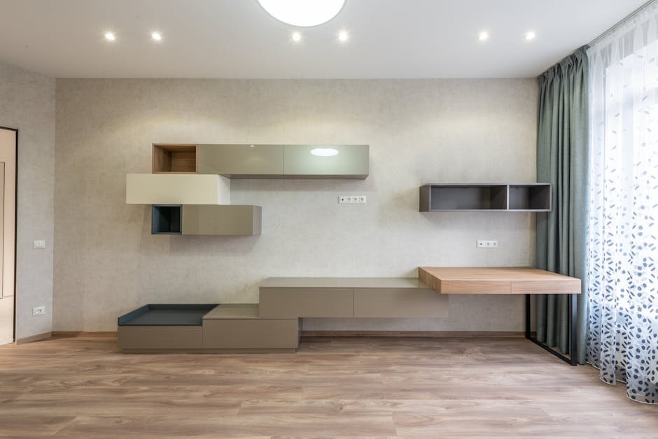 pexels-photo-6489097-6489097 Spacious and bright modern living room with minimalist shelving and elegant decor.